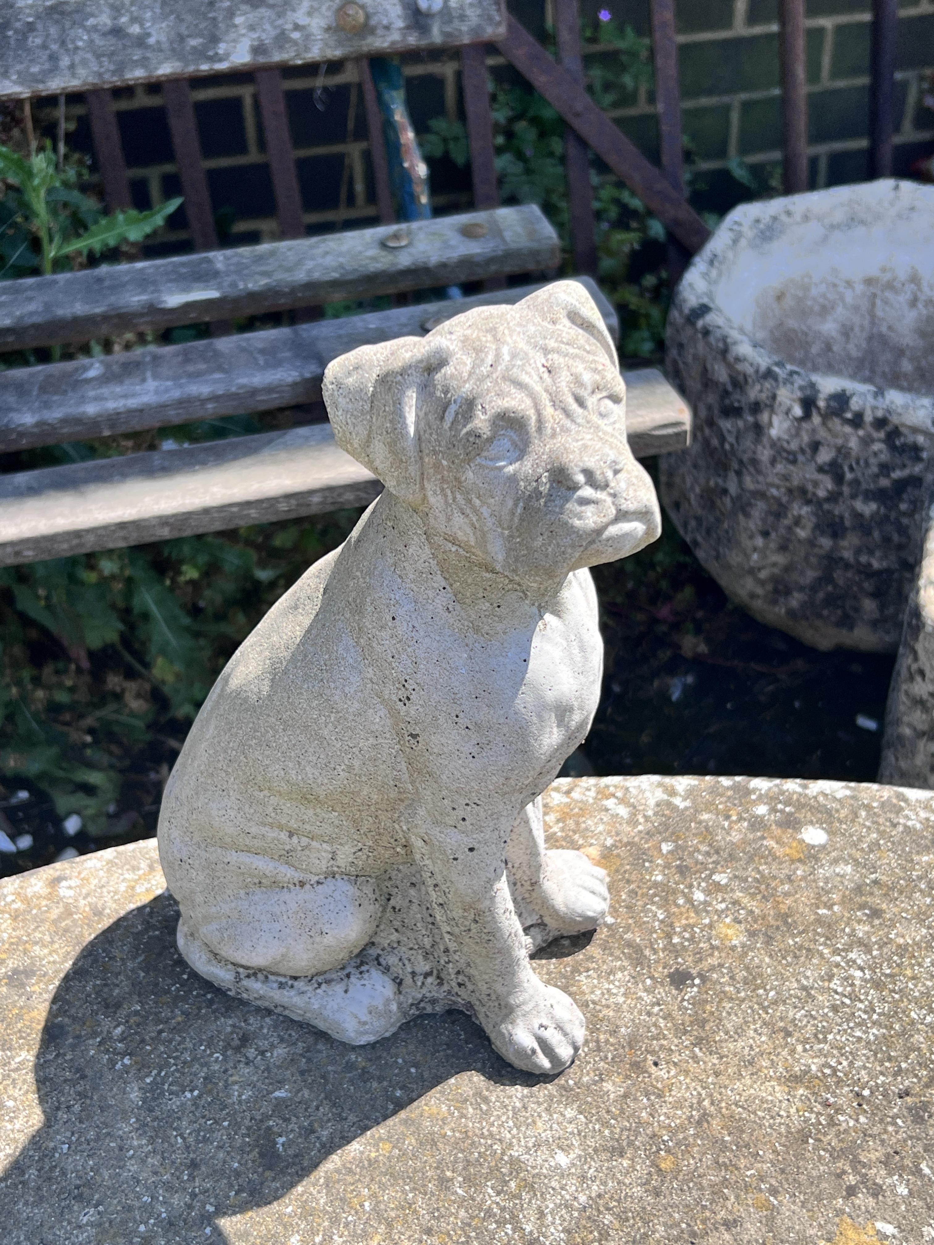 A small reconstituted stone curved garden bench, width 110cm, height 44cm, together with a stone pedestal and a small dog ornament